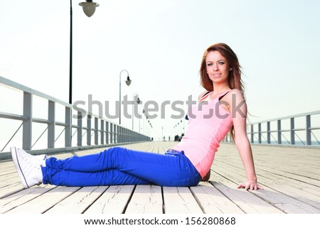 Attractive girl Young woman on pier Sits Relaxing Old Wooden Pier