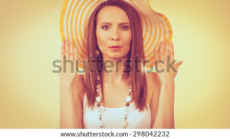 Holidays summer fashion and head protection. Woman in big yellow hat. Portrait of charming female on bright background.