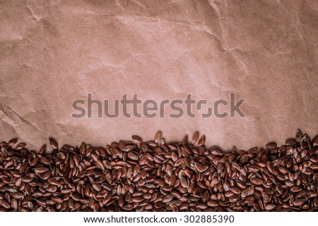Healthy diet organic nutrition. Brown raw flax seeds linseed border frame on paper background