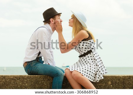 Summer holidays love relationship and dating concept - romantic playful couple retro style flirting on sea shore