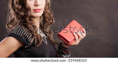 Fashion elegant evening outfit. Close up elegant woman holding red leather handbag clutch bag on dark background