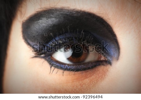 woman Beautiful shape of female eye with black blue cosmetic make-up Professional make up