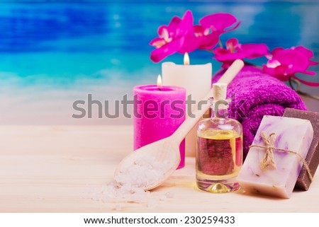 Image of spa concept with flowers, candles, sea salt, oil, towel and natural bar of soap