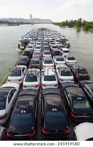 VIENNA, AUSTRIA - SEPTEMBER 15, 2011: Shipping barge full of new cars on September 15, 2011 in Vienna, Austria. Danube River, designated as Corridor 7 is an important nautical transportation route.