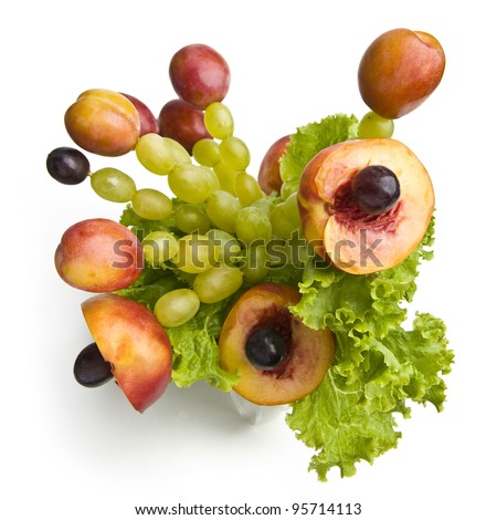 Bouquet made of fruits - peaches, plums, grape and salad.
