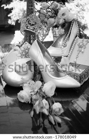 Vintage black and white photo wedding supplies bride. White mother of pearl and seashell shoes in a spiral shape. Wedding decor, jewelry, boudoir accessories.
