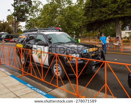 SANTA BARBARA, CA - May 14, 2015: The California Highway Patrol car at the end of the convoy waits at the curb before the start of stage 5 of the Amgen Tour of California bicycle race.