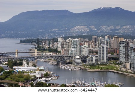 A view of Vancouver, British Columbia\'s West End. False Creek and English Bay are in the foreground, the Coastal Mountains in the background.