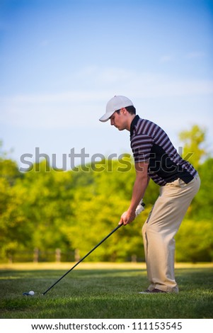 Young Golfer Swing Club under Summer Blue Sky