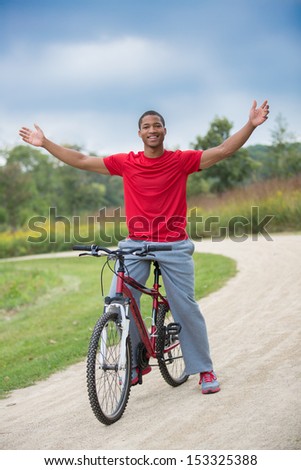 Smiling Healthy Looking Young African American Biking Outdoor