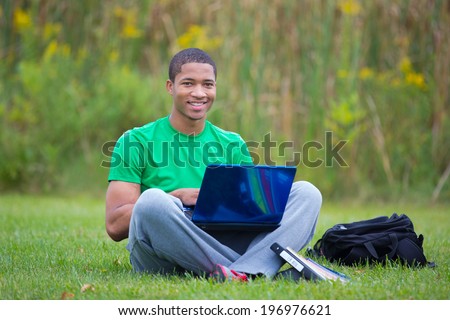 Happy African American College Student Holding Laptop Studying outdoor