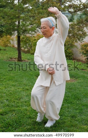 Chinese Elderly Woman Performing Taichi Outdoor