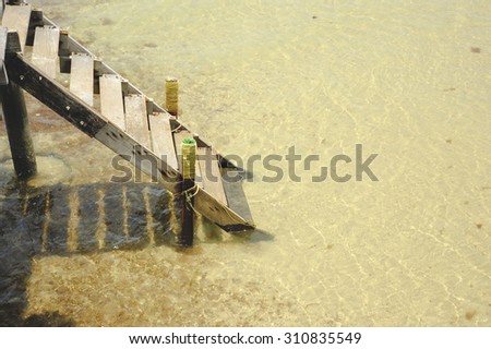 ladder on Wooden pier, Summer, Travel, Vacation and Holiday concept - Wooden pier in Kho mak, Thailand