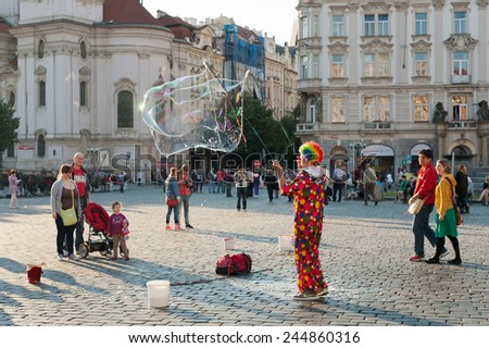 PRAGUE, CZECH REPUBLIC - MAY 19, 2014: Street artist makes soap bubbles at Old Town Square