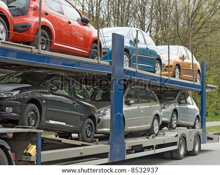 car carrier truck deliver new auto batch to dealer