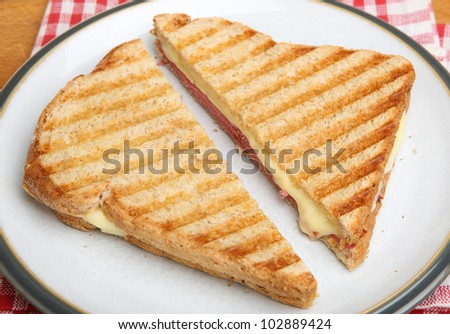 Toasted sandwich with beef pastrami and melting cheese