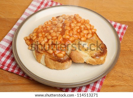 Baked beans on toast with steam rising.
