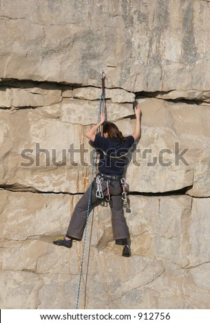 Young female scaling rockface