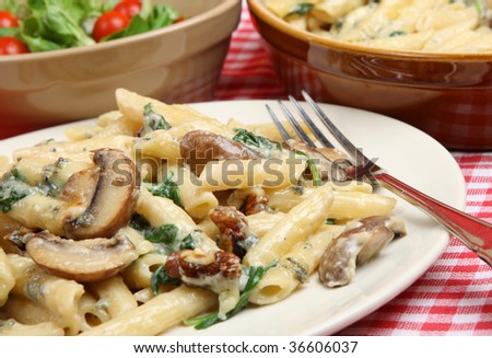 Rigatoni pasta with four cheese sauce, mushrooms, walnuts and spinach