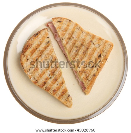 Toasted sandwich with ham & cheese, on wholewheat bread.