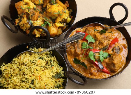Lamb korma curry with aloo gobi and pilau rice.