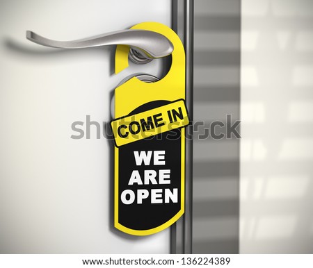 door hanger with the message come in we are open hanged on a door handle.
