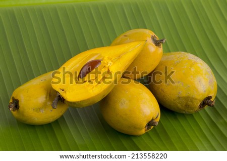 Egg fruit, Canistel, Yellow Sapote (Pouteria campechiana (Kunth) Baehni) on banana leaf background.