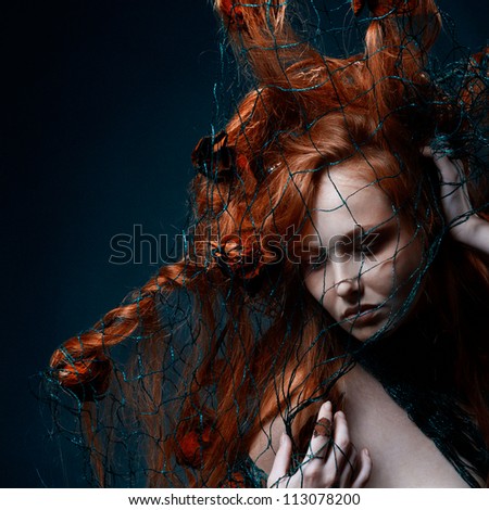 Beautiful girl with surreal hair style with dry roses and net. Tonalities are added./Roses