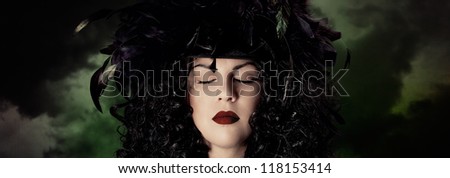 Dark portrait of woman in a strange hat. /The Night