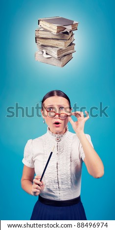 Angry teacher with books over her head/Angry teacher