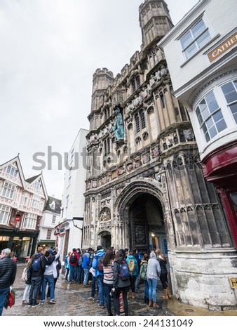 CANTERBURY, UK - JAN 13, 2015. Students gather outside Canterbury cathedral entrance. In 1170 Archbishop Thomas Becket was murdered in the Cathedral which now attracts thousands of tourists.