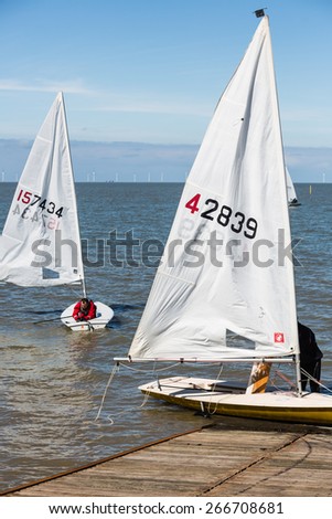 HERNE BAY, UK - APRIL 5, 2015. Members of Herne Bay sailing club enjoy their sport, setting off from their own slipway, on a sunny Easter Sunday bank hoilday in Kent.