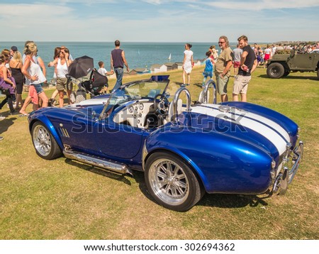 Whitstable, UK, 2nd August 2015. A blue vintage AC Cobra  sports car is on display for visitors to Tankerton slopes to enjoy during the classic car motor show in Whitstable, Kent.
