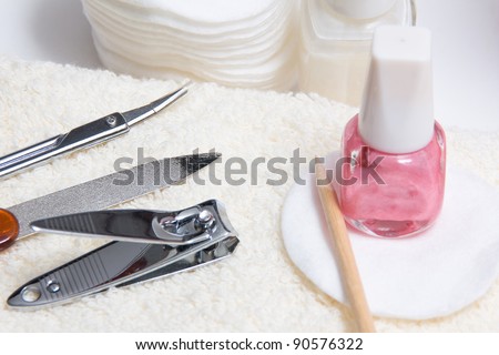 Various tools of a manicure set on a towel