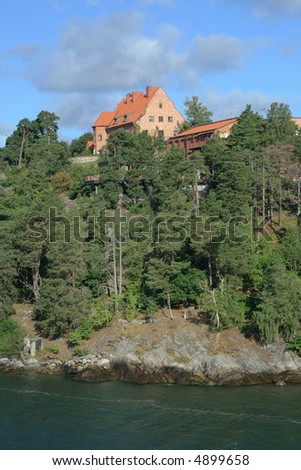 a single house on a cliff near sea