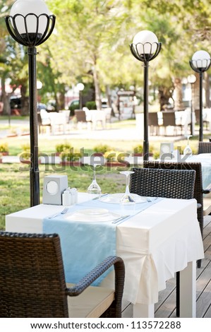 Tables setting at outside dining area of restaurant.