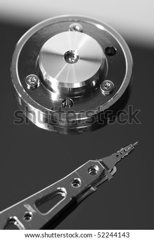 Hard Drive Platter with Read head on Disc in black and white.