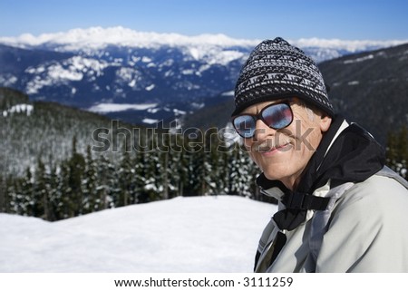 Caucasian senior man  skier in goggles posing on mountain Whistler, British Columbia, Canada.