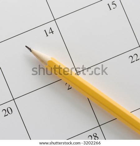 Pencil on top of a blank calendar.