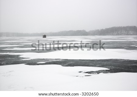 Scenic of frozen lake with ice fishing shack in Green Lake, Minnesota, USA.