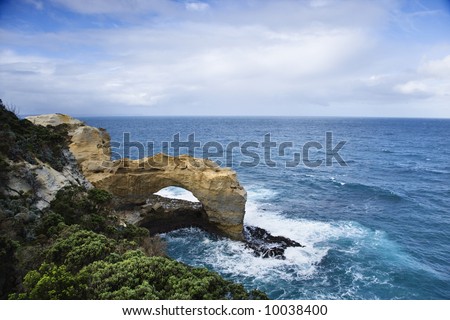 Rock in arch shape on coastline of Australia as seen from Great Ocean Road.
