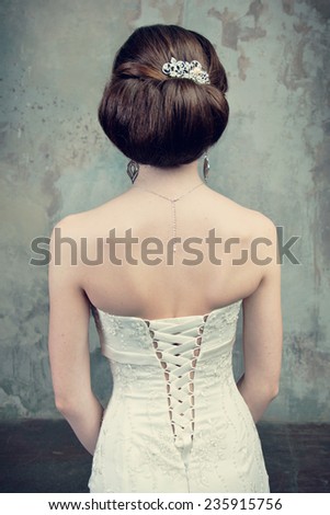 beautiful girl in the dress of the bride from the back on the stairs