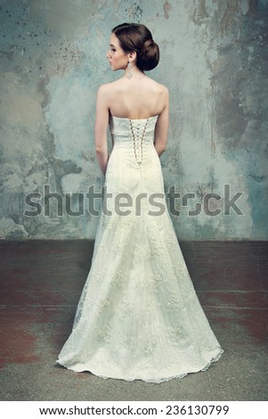 beautiful girl in the dress of the bride from the back