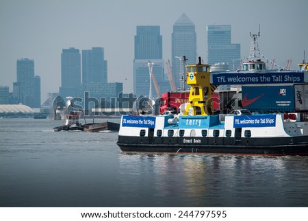 LONDON, UK - SEPTEMBER 9TH, 2014: A TfL (Transport for London) ferry welcomes ships participating in the Tall Ship Festival on the River Thames in London.