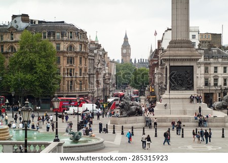 London, UK - May 23rd, 2015: tourists enjoying themselves in Trafalgar Square among the famous fountains, lions, Nelson\'s Column, and other must-see London attractions.