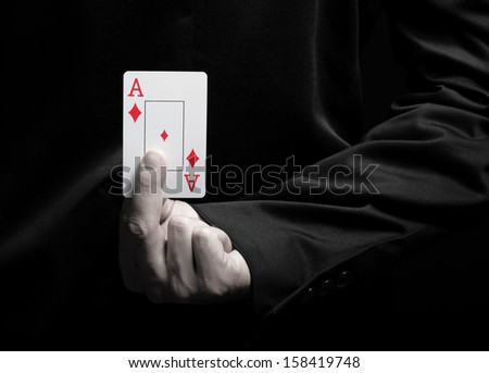 Businessman showing ace card behind his back