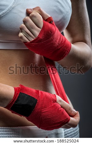 Boxing woman binds the bandage on his hand, before training, detail photo