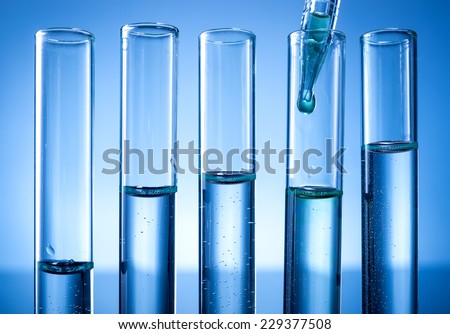 Laboratory equipment, test tubes line, a drop of liquid