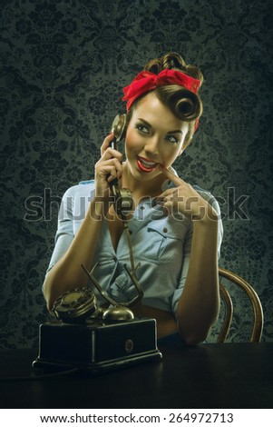 Vintage style - Woman talking on the phone with retro dial phone