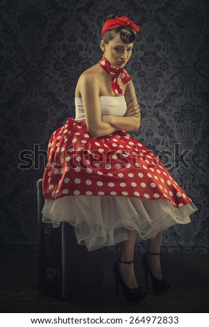 Vintage style - Woman sitting in the room with red polka dot dress